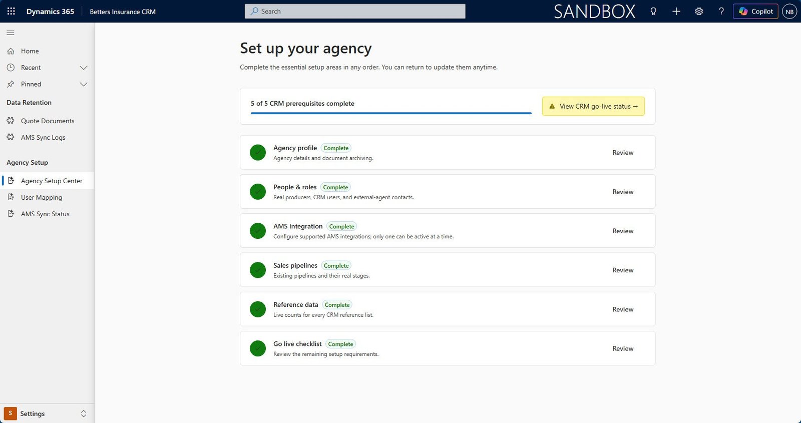 A guided agency setup screen in Dynamics 365 showing six setup areas with completion status and a go-live checklist
