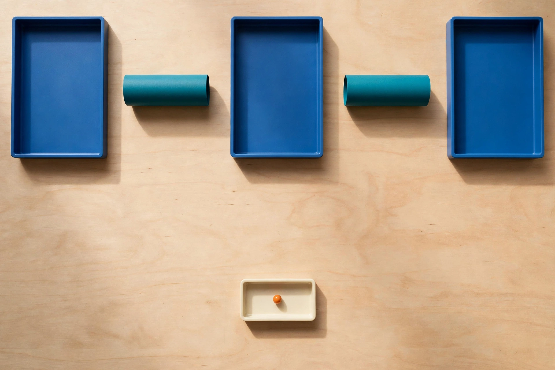 Three blue rectangular trays are arranged horizontally with gaps between them, each containing a teal cylinder outside the trays.